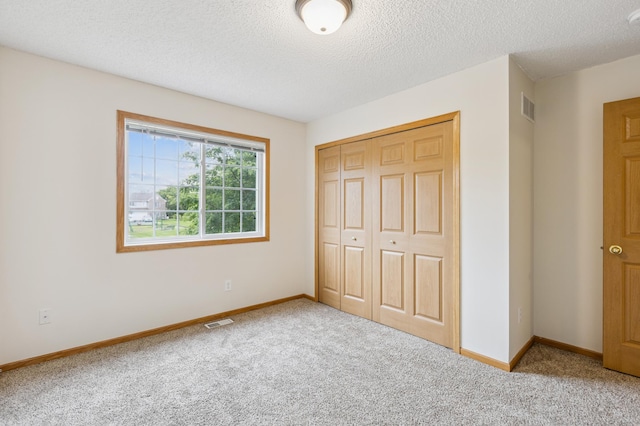 17128 Olson St NW Unit 2508, Elk River, MN 55330 - unfurnished bedroom with carpet flooring, a closet, and a textured ceiling