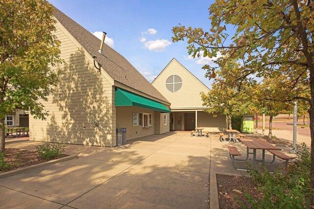6541 Beach Rd, Eden Prairie, MN 55344 - rear view of house with a patio and roof with shingles