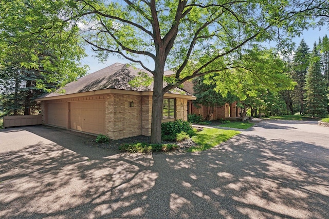 6541 Beach Rd, Eden Prairie, MN 55344 - view of side of property with brick siding, driveway, and an attached garage