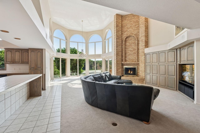 6541 Beach Rd, Eden Prairie, MN 55344 - living room featuring a fireplace, a towering ceiling, and light carpet