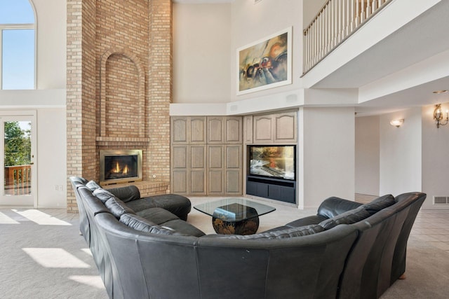 6541 Beach Rd, Eden Prairie, MN 55344 - living room featuring a towering ceiling, a fireplace, and light colored carpet