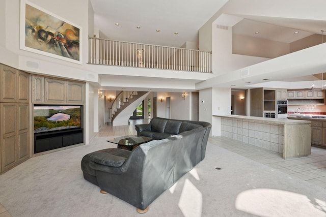 6541 Beach Rd, Eden Prairie, MN 55344 - living room with a towering ceiling, stairs, light tile patterned floors, light carpet, and recessed lighting
