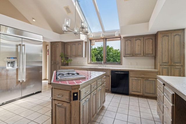 6541 Beach Rd, Eden Prairie, MN 55344 - kitchen with appliances with stainless steel finishes, light tile patterned floors, lofted ceiling, decorative light fixtures, and a kitchen island