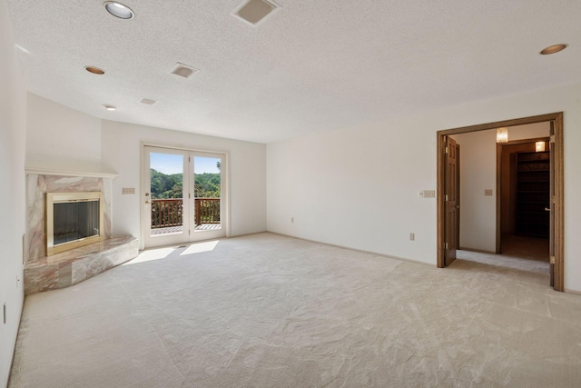 6541 Beach Rd, Eden Prairie, MN 55344 - unfurnished living room with light colored carpet, a textured ceiling, a fireplace, and recessed lighting