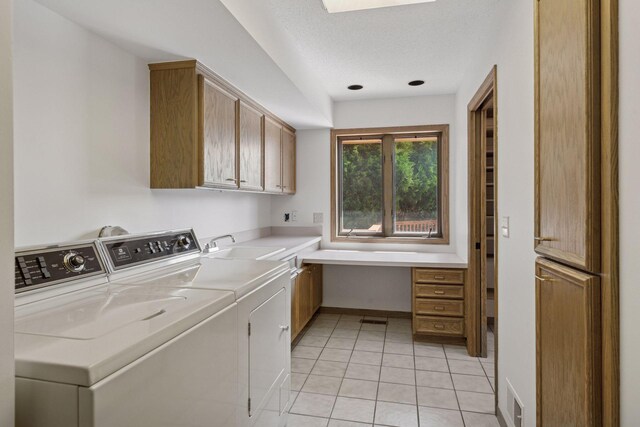 6541 Beach Rd, Eden Prairie, MN 55344 - laundry area featuring cabinet space, washer and dryer, and light tile patterned floors