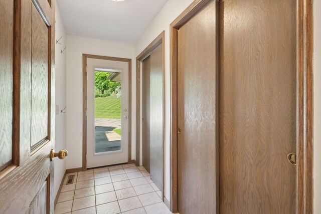 6541 Beach Rd, Eden Prairie, MN 55344 - doorway to outside featuring light tile patterned floors and baseboards