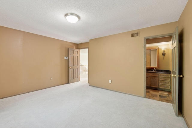 6541 Beach Rd, Eden Prairie, MN 55344 - unfurnished bedroom with carpet flooring, a textured ceiling, and connected bathroom