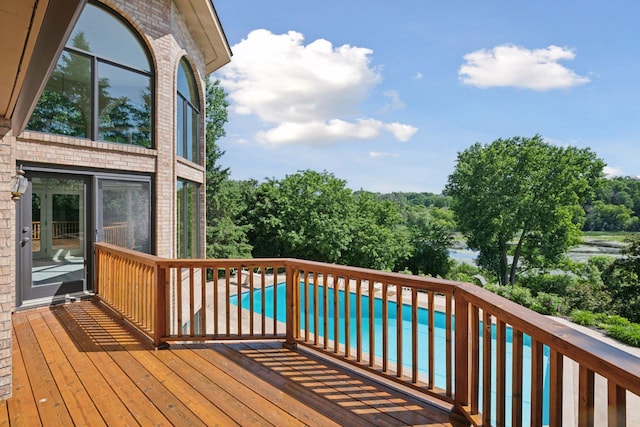 6541 Beach Rd, Eden Prairie, MN 55344 - deck with an outdoor pool and view of wooded area