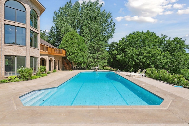 6541 Beach Rd, Eden Prairie, MN 55344 - outdoor pool with a patio area and view of wooded area
