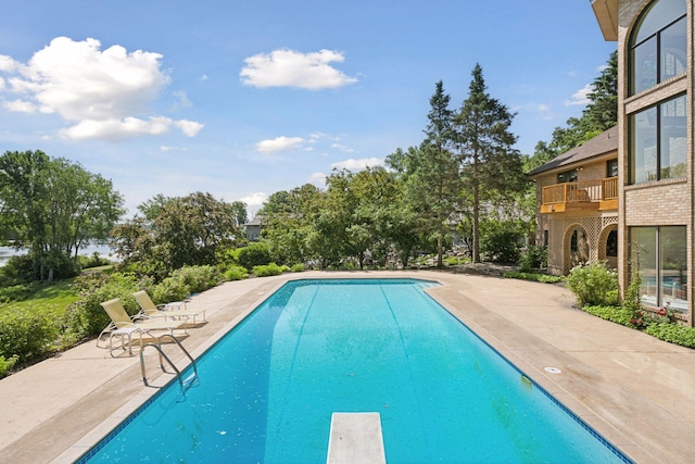 6541 Beach Rd, Eden Prairie, MN 55344 - outdoor pool featuring a diving board, a patio, and view of scattered trees