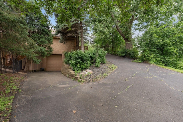 6541 Beach Rd, Eden Prairie, MN 55344 - view of side of home featuring asphalt driveway and an attached garage