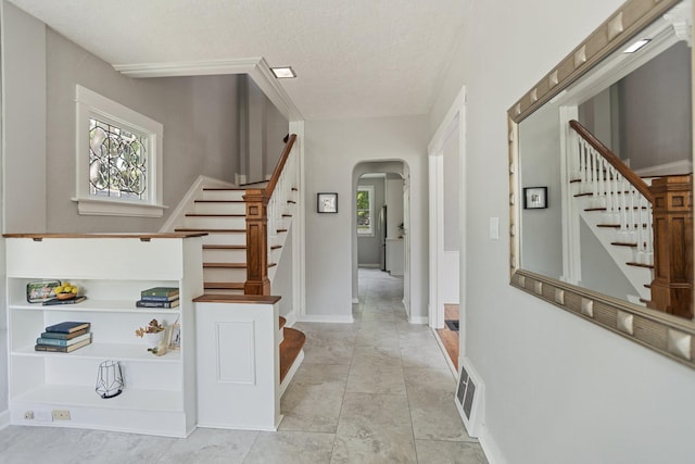 810 7th St NW, Faribault, MN 55021 - stairs featuring arched walkways and a textured ceiling