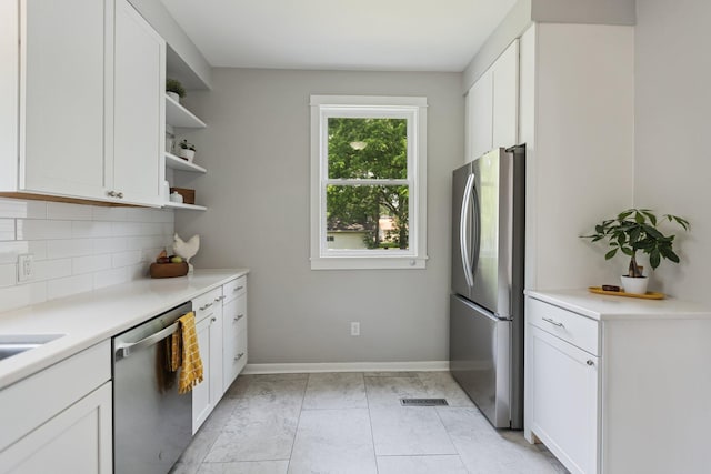 810 7th St NW, Faribault, MN 55021 - kitchen with stainless steel appliances, open shelves, decorative backsplash, and white cabinets