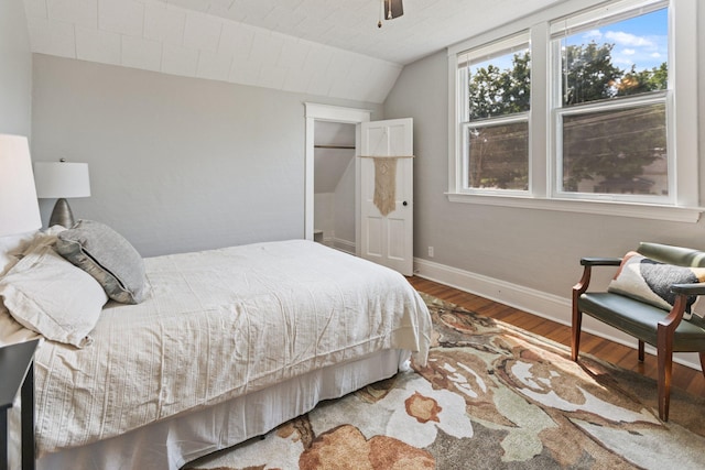 810 7th St NW, Faribault, MN 55021 - bedroom featuring wood finished floors, vaulted ceiling, and a ceiling fan