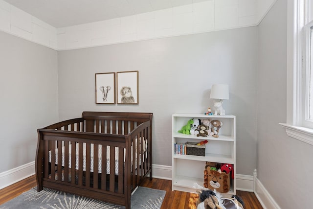810 7th St NW, Faribault, MN 55021 - bedroom with a nursery area and wood finished floors