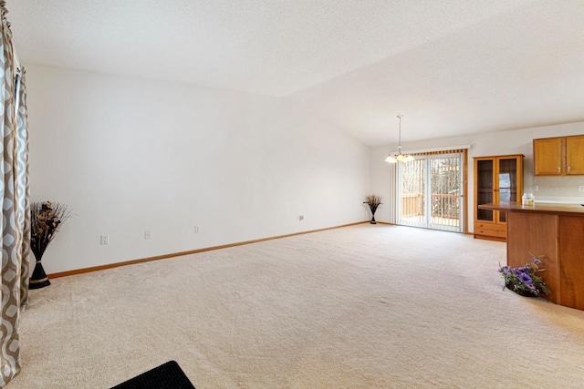 4929 Valley Dr NW, Rochester, MN 55901 - unfurnished living room featuring light colored carpet, a chandelier, and lofted ceiling