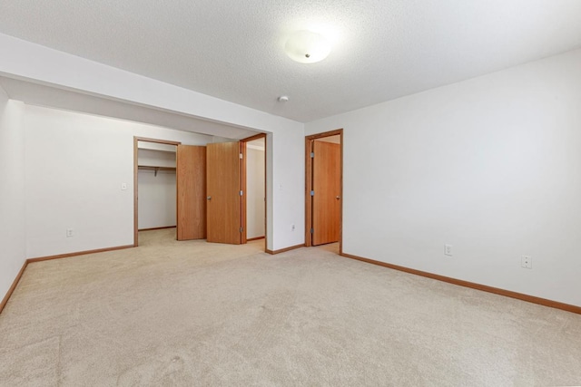 4929 Valley Dr NW, Rochester, MN 55901 - unfurnished bedroom featuring light colored carpet and a textured ceiling