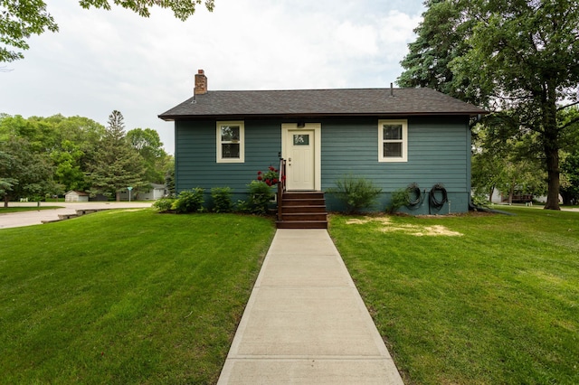 202 Park St, Alexandria, MN 56308 - view of front facade with a chimney, a front yard, and a shingled roof