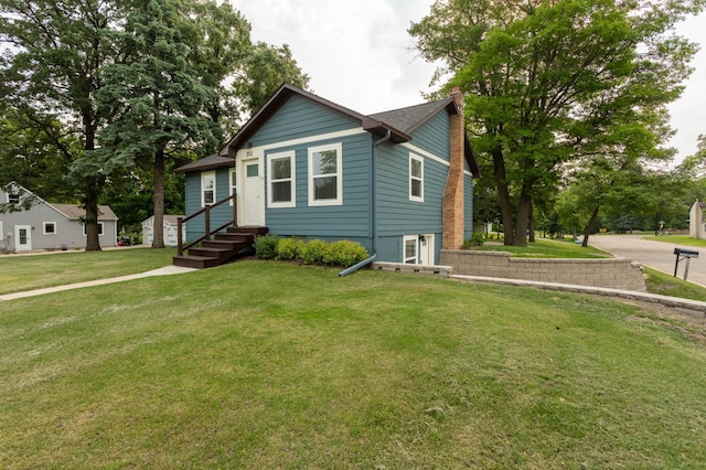 202 Park St, Alexandria, MN 56308 - bungalow featuring a chimney, a front yard, and entry steps