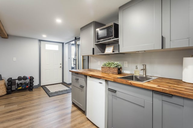 202 Park St, Alexandria, MN 56308 - kitchen featuring wood counters, stainless steel microwave, gray cabinetry, light wood-type flooring, and recessed lighting