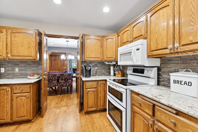8011 County Road 13 SE, Delano, MN 55328 - kitchen featuring white appliances, backsplash, light wood-style flooring, light stone counters, and recessed lighting