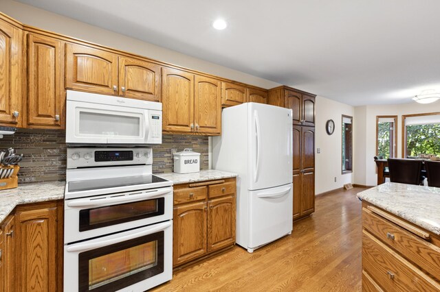 8011 County Road 13 SE, Delano, MN 55328 - kitchen featuring white appliances, light wood finished floors, tasteful backsplash, brown cabinetry, and recessed lighting