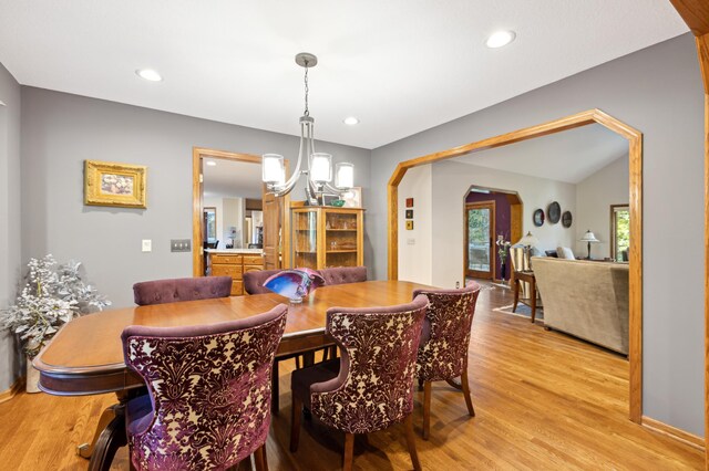 8011 County Road 13 SE, Delano, MN 55328 - dining room with light wood finished floors, a chandelier, arched walkways, and recessed lighting