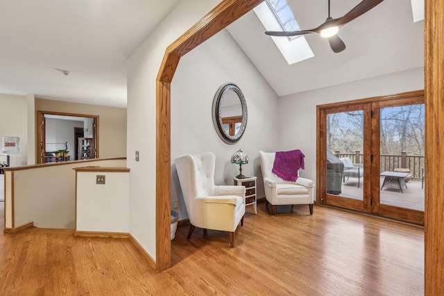 8011 County Road 13 SE, Delano, MN 55328 - living area featuring a skylight, a ceiling fan, light wood finished floors, and vaulted ceiling