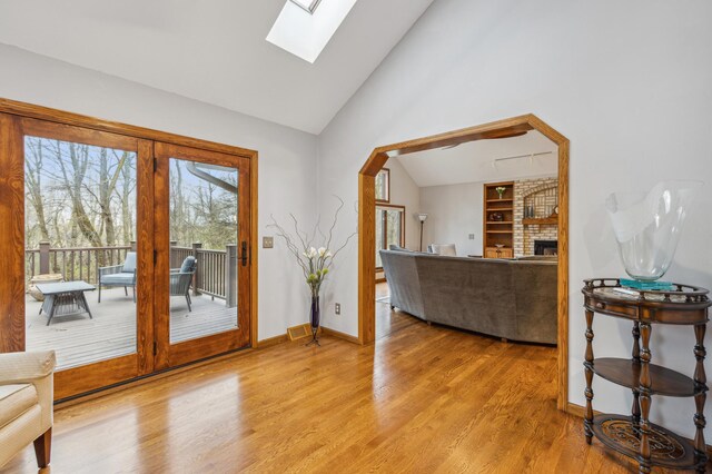 8011 County Road 13 SE, Delano, MN 55328 - entrance foyer with a skylight, light wood finished floors, a brick fireplace, and high vaulted ceiling