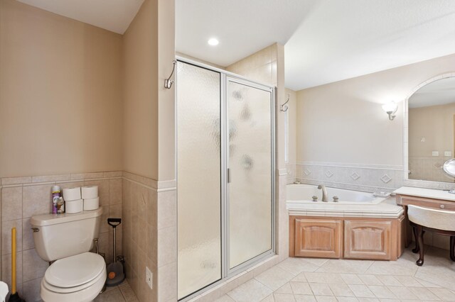 8011 County Road 13 SE, Delano, MN 55328 - bathroom with tile patterned flooring, a shower stall, tile walls, a bath, and a wainscoted wall