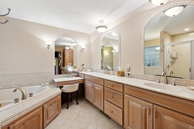 8011 County Road 13 SE, Delano, MN 55328 - bathroom featuring tile patterned flooring, double vanity, a shower stall, a bath, and a wainscoted wall