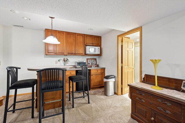 8011 County Road 13 SE, Delano, MN 55328 - kitchen featuring white microwave, light colored carpet, decorative light fixtures, brown cabinetry, and recessed lighting
