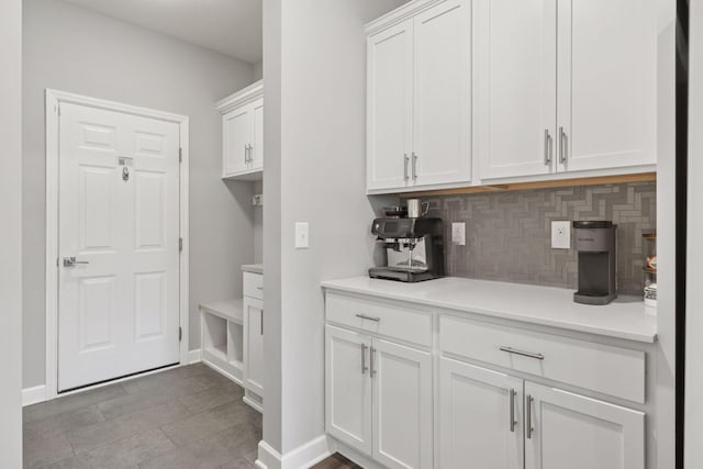 3841 Hyde Ave N, Oakdale, MN 55128 - kitchen with tasteful backsplash, white cabinetry, and light countertops