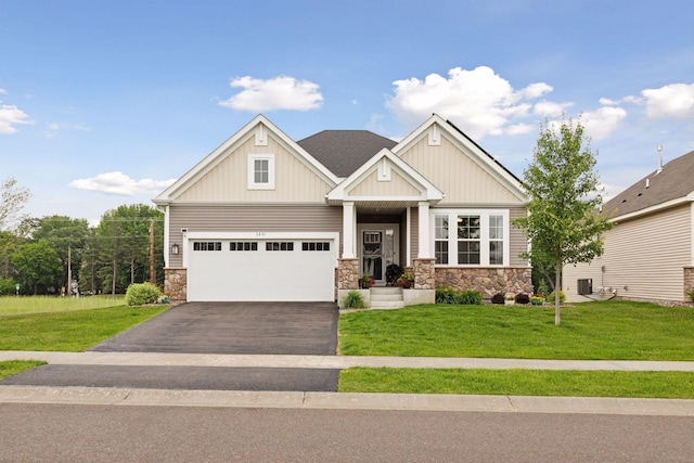 3841 Hyde Ave N, Oakdale, MN 55128 - craftsman inspired home featuring stone siding, driveway, a front yard, and board and batten siding
