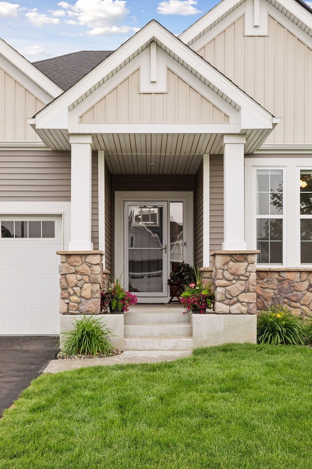 3841 Hyde Ave N, Oakdale, MN 55128 - property entrance with stone siding, board and batten siding, a porch, a lawn, and a garage