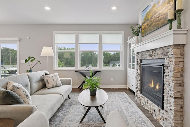 3841 Hyde Ave N, Oakdale, MN 55128 - living area with a stone fireplace, dark wood-style floors, and recessed lighting