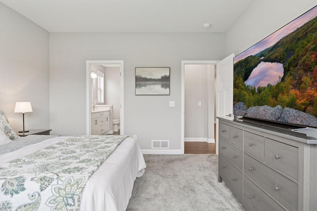3841 Hyde Ave N, Oakdale, MN 55128 - bedroom with light colored carpet and connected bathroom
