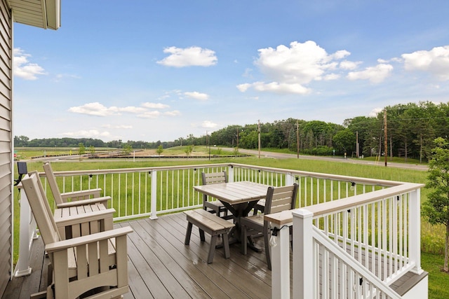 3841 Hyde Ave N, Oakdale, MN 55128 - deck featuring outdoor dining space, a lawn, and a view of rural / pastoral area