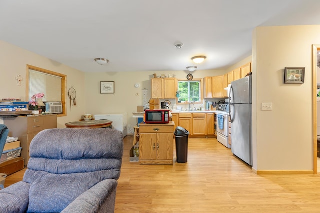 13143 County Road 116, Center Twp, MN 56465 - kitchen with open floor plan, freestanding refrigerator, light wood-style floors, white stove, and light brown cabinetry