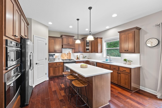 13332 Coachford Ave, Rosemount, MN 55068 - kitchen featuring stainless steel appliances, a kitchen breakfast bar, a kitchen island, dark wood finished floors, and light countertops