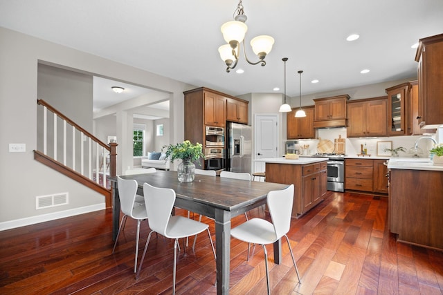 13332 Coachford Ave, Rosemount, MN 55068 - dining space featuring a chandelier, dark wood finished floors, stairway, and recessed lighting