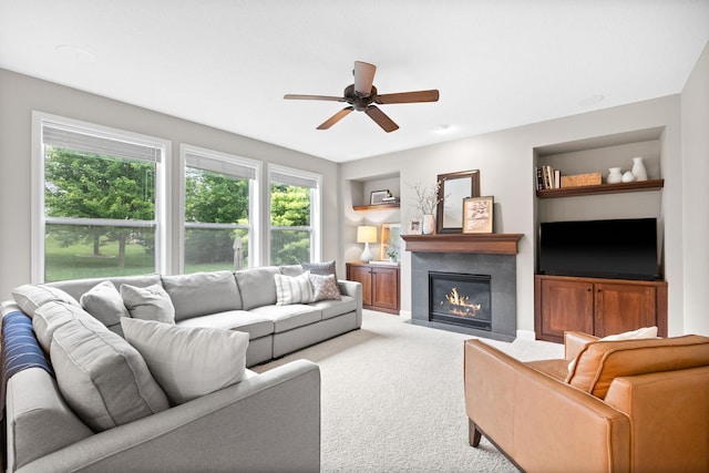 13332 Coachford Ave, Rosemount, MN 55068 - carpeted living room featuring a ceiling fan, healthy amount of natural light, built in shelves, and a fireplace with flush hearth