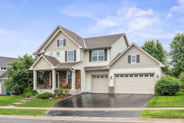 13332 Coachford Ave, Rosemount, MN 55068 - craftsman-style home featuring driveway, covered porch, stone siding, and an attached garage