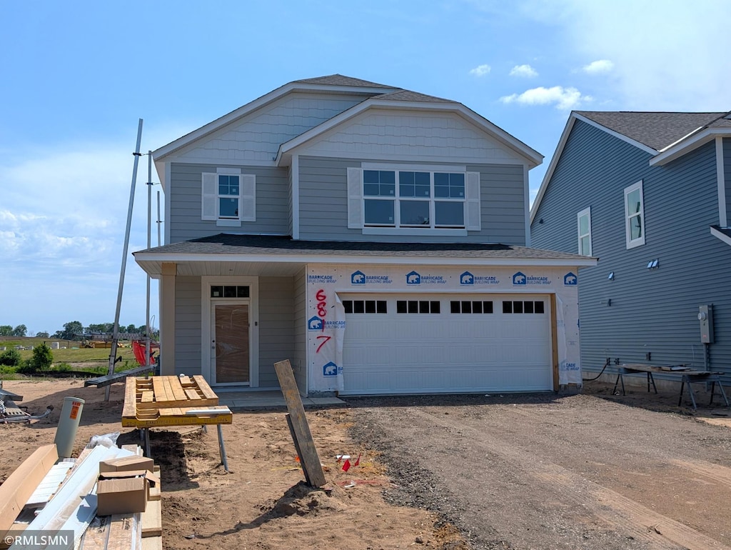 6817 104th St S, Cottage Grove, MN 55016 - view of front facade with driveway and an attached garage
