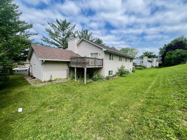 7315 Bagpipe Blvd, Eden Prairie, MN 55346 - rear view of property featuring a yard, a deck, a chimney, and roof with shingles
