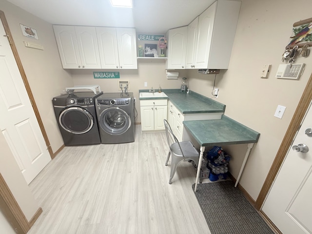 2228 Douglynn Ln, Saint Paul, MN 55119 - washroom featuring cabinet space, washer and dryer, and light wood-style flooring