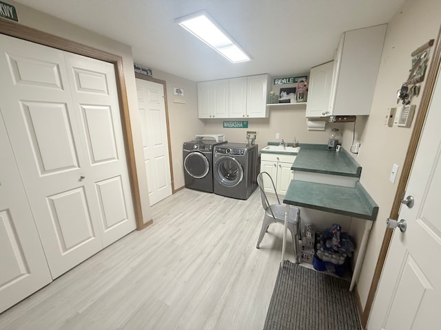 2228 Douglynn Ln, Saint Paul, MN 55119 - laundry room with cabinet space, independent washer and dryer, and light wood finished floors