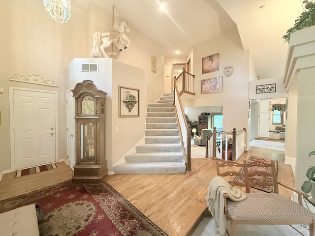 2228 Douglynn Ln, Saint Paul, MN 55119 - foyer entrance featuring high vaulted ceiling, stairs, and wood finished floors