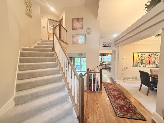 2228 Douglynn Ln, Saint Paul, MN 55119 - stairway featuring wood finished floors and a towering ceiling