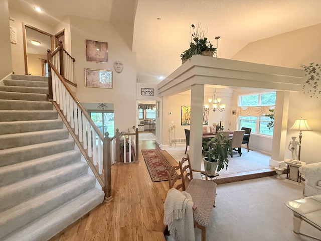 2228 Douglynn Ln, Saint Paul, MN 55119 - foyer featuring a chandelier, stairway, light wood-style floors, and high vaulted ceiling
